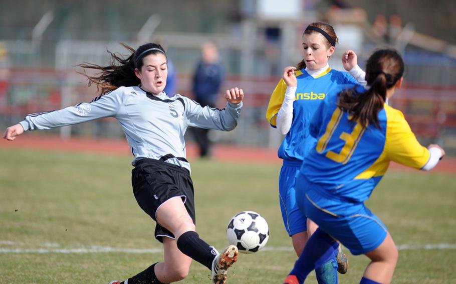Heidelberg's Layna Lowe gets off a shot against Ansbach's Delaney Dickey and Dannielle O'Buckley in the season opener Saturday in Heidelberg. Lowe scored a goal and Anna Miller added three more as the Lions defeated the Cougars 4-0.
