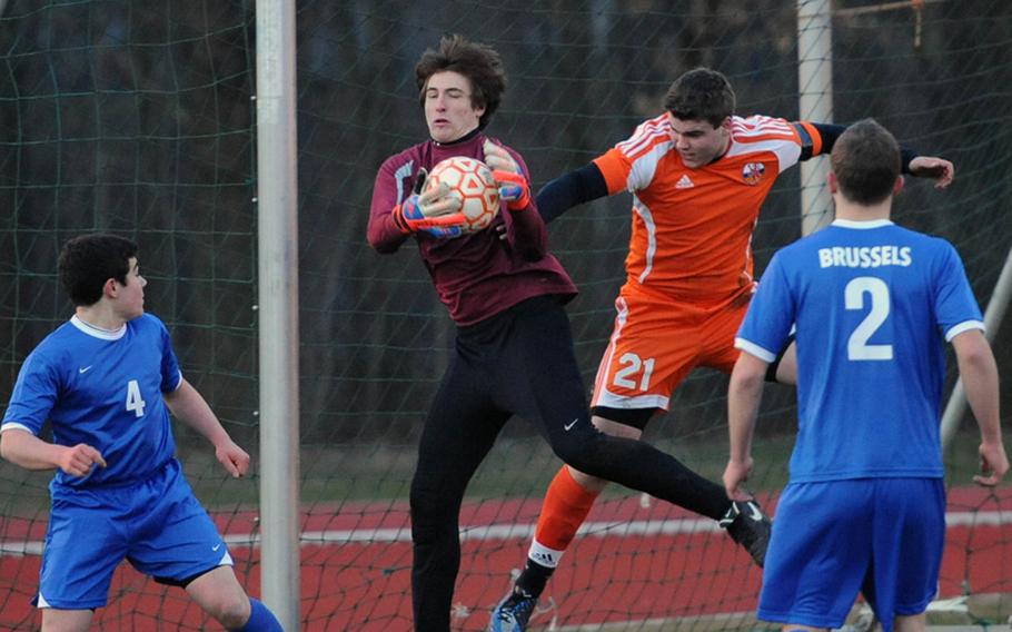 Brussels keeper Danny Helbling pulls in the ball against a flying Luke Narug of AFNORTH in the season opener for both teams at AFNORTH on Thursday. The Lions defeated the Brigands in an exciting game 5-4.