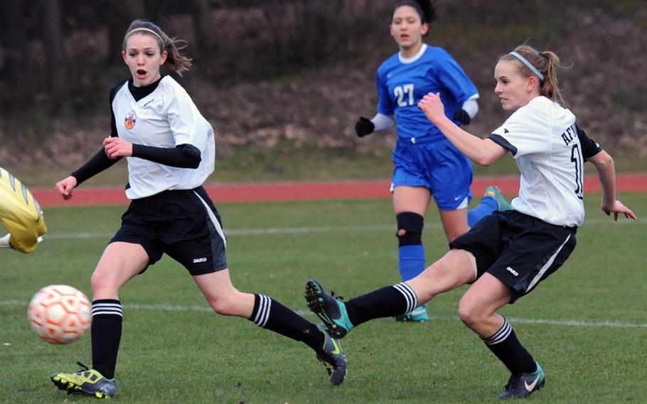 Hope BonenClark, right, scores to put her team up 1-0 against Brussels Thursday evening. The season opener for both teams ended in a 1-1 tie.