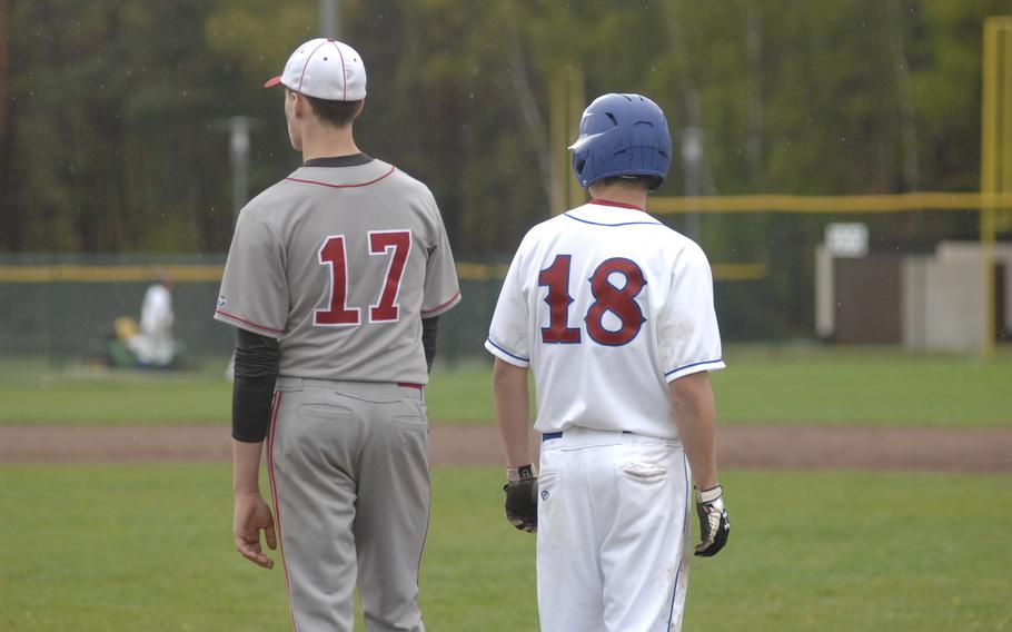 Ramstein's Robbie Levin, right, stands on first base next to Kaiserslautern's Chris Jastrab in Ramstein's 16-0 victory on Friday. 