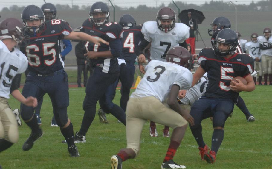 Bitburg running back Kenny Love crosses the goal line before Baumholder's Isaiah Wilson can apply a hit Saturday at Bitburg, Germany. Bitburg won the game 42-6 and set a new DODDS-Europe record with its 32nd consecutive victory.