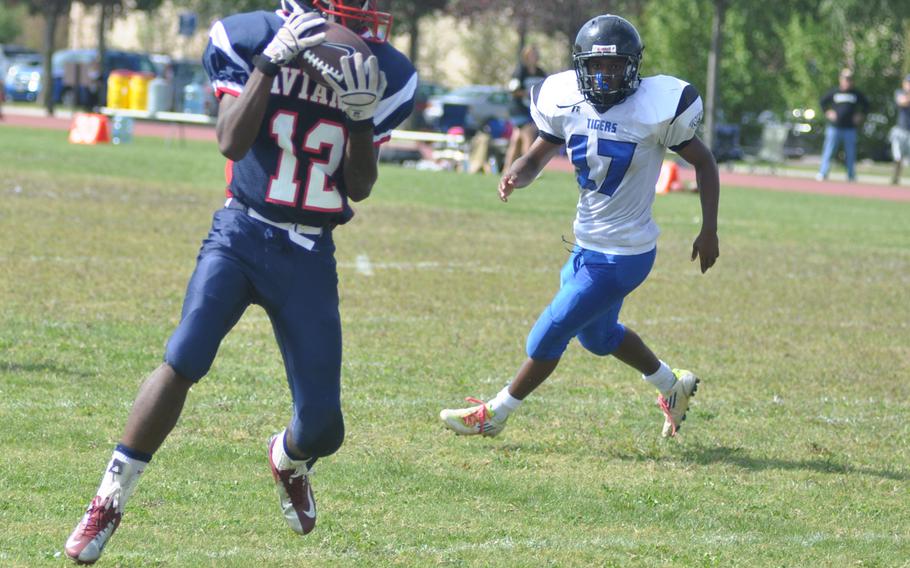 Aviano's Jamal Thomas catches a pass as Hohenfels' AJ Day looks on during a game Saturday at Aviano Air Base, Italy. Thomas had 11 grabs for 97 yards,  including a touchdown . Hohenfels won 41-24.