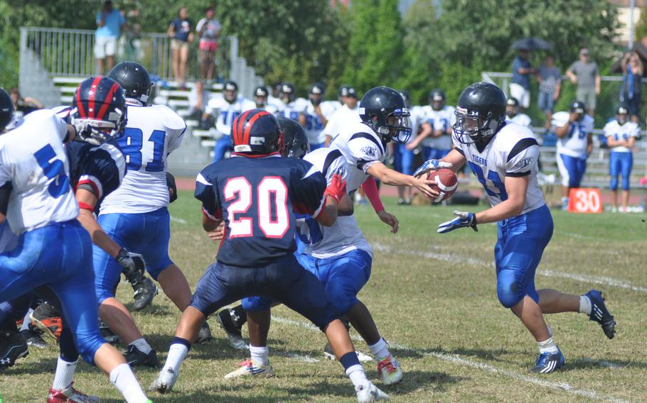 Hohenfels' Clayton Pinheiro hands the ball off to David Vidovic, who rushed 15 times for 198 yards Saturday during a game against Aviano at Aviano Air Base, Italy. Hohenfels won 41-22  