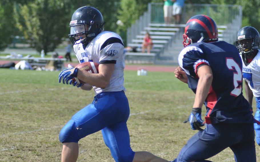 Hohenfels' David Vidovic runs past Aviano's Mike Trujillo to score one of his four touchdowns during Saturday's game at Aviano Air Base, Italy. Vidovic rushed 15 times for 198 yards and had one reception for 79 yards, leading Hohenfels to win 41-22.