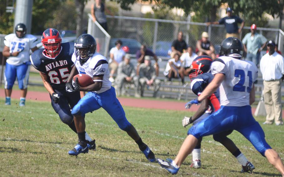 Hohenfels' Marcus Dudley Jr. runs past Aviano's Lino Zanussi during Saturday's game at Aviano Air Base, Italy. Dudley ran 45 yards and scored a touchdown off an interception assisting Hohenfels in a 41-22 win.
