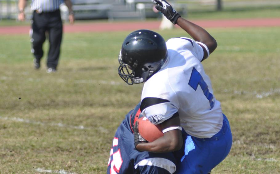 Hohenfels' Marcus Dudley Jr. gets wrapped up by Aviano's Te'Kevin Boston during Saturday's game at Aviano Air Base, Italy. Dudley ran 45 yards and scored a touchdown off an interception assisting in Hohenfels' 41-22 win.