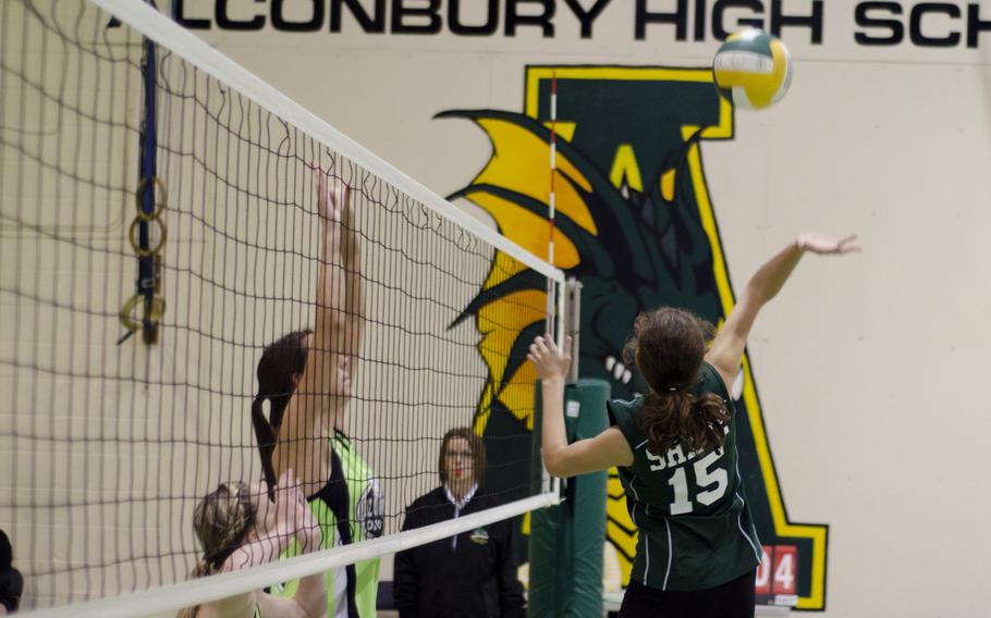 Begoña Rodriguez Bravo of SHAPE attempts a return to Alconbury defenders Saturday, during a volleyball match at RAF Alconbury, England. Alconbury won all three matches against SHAPE, 25-6, 25-23, 25-8.
