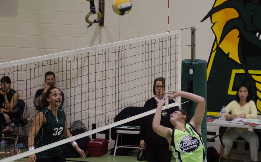 Alconbury senior Leila Hall sends a reverse-lob to SHAPE defenders Saturday, during a girls volleyball match at RAF Alconbury, England. Alconbury added to its winning season by defeating SHAPE in three straight matches, 25-6, 25-23, 25-8.
