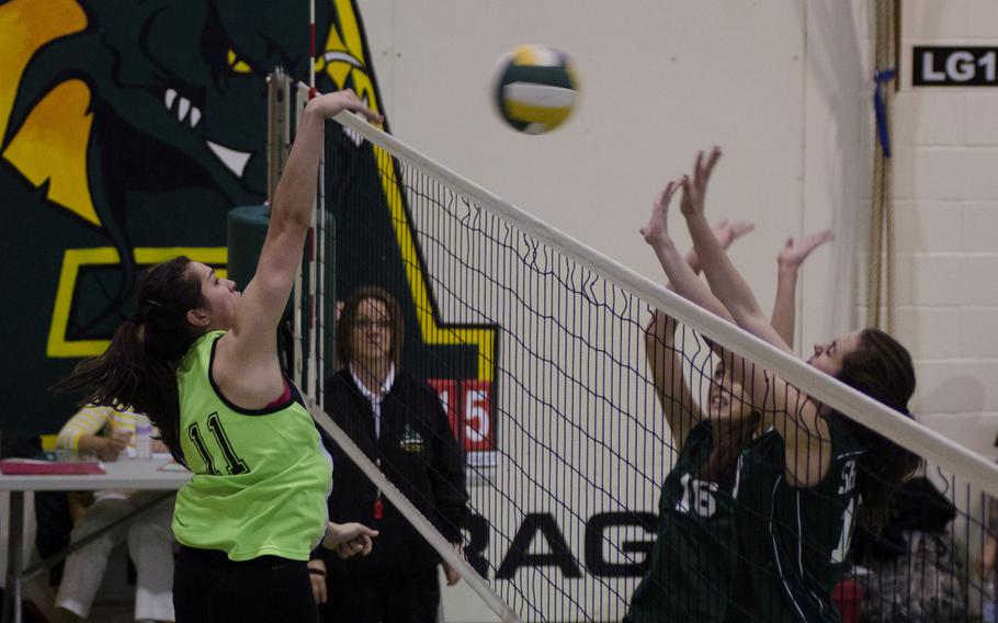 Alconbury junior Leila Hall hits the ball against SHAPE defenders at RAF Alconbury, England, during a match Saturday. SHAPE put up a strong effort in the second game, but lost three straight matches, 25-6, 25-23, 25-8.
