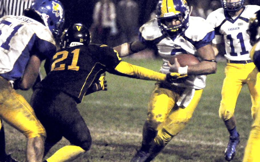 Ansbach's Dorian Jones tries to elude the tackle of Vicenza's Nathan Fullmer during Friday night's battle of the Cougars in Vicenza, Italy. Ansbach won 25-6.