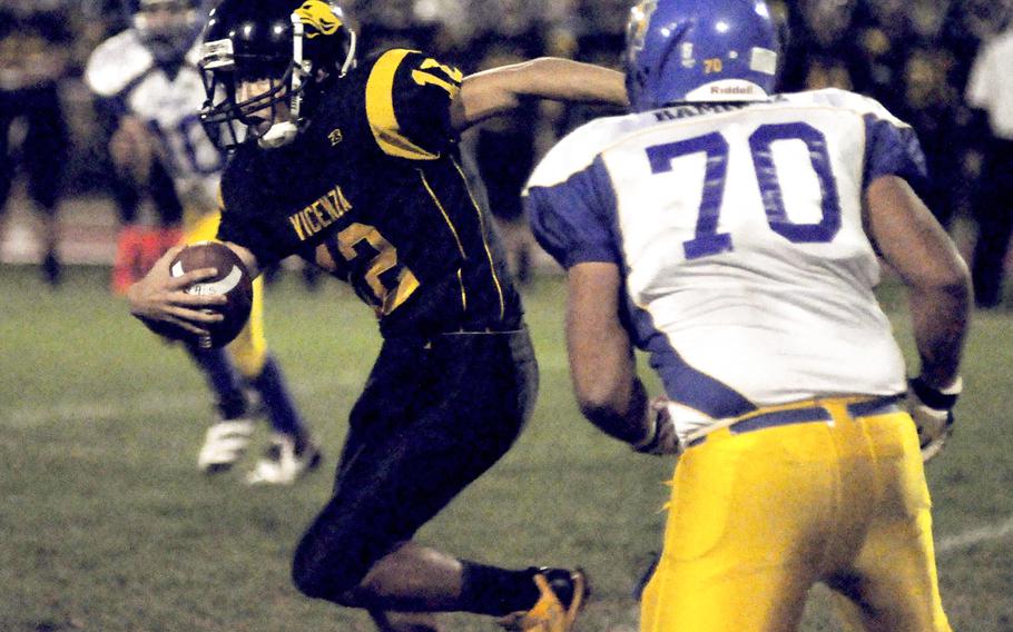 Vicenza quarterback Mario Molina tries to elude Ansbach's Miguel Ramirez on Friday night. Ansbach won the game 25-6 and stayed unbeaten to finish the regular season.