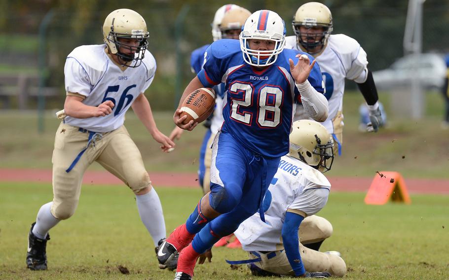 Ramstein's Tevin Johnson gets past a bevy of Wiesbaden defenders on his way to the end zone in the Royals' 20-7 win over the visiting Warriors Saturday, Oct. 12, 2013.