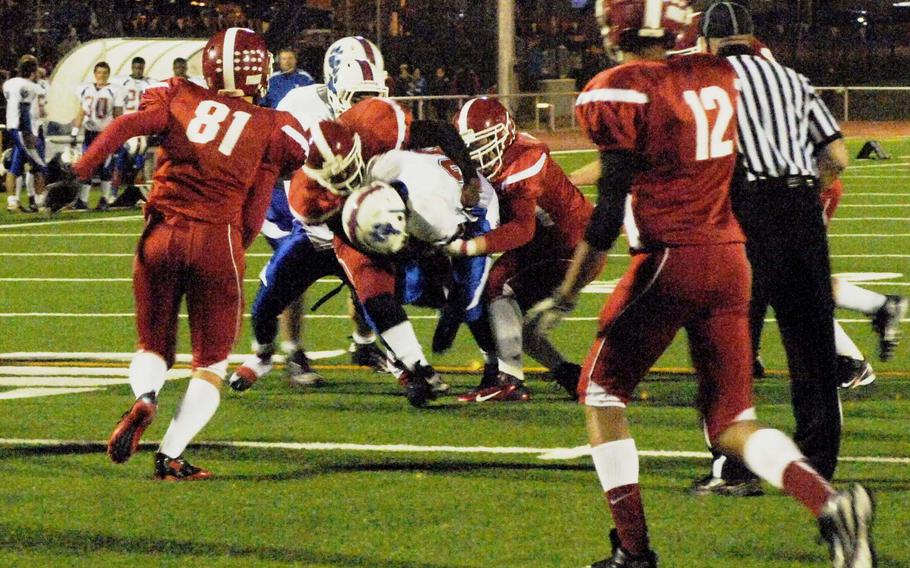 Ramstein running back Santee Jackson is wrapped up by Kaiserslautern defenders in Ramstein's 46-0 win over Kaiserslautern on Friday at Kaiserslautern, Germany.
