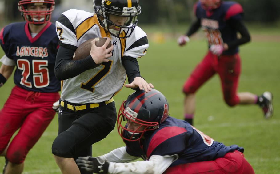 Patch freshman Holten Sparling attempts to run past a Lakenheath defender Saturday, Oct. 19, 2013, during a game at RAF Lakenheath, England. Patch won 28-27 and will advance to the European Division I semifinals.