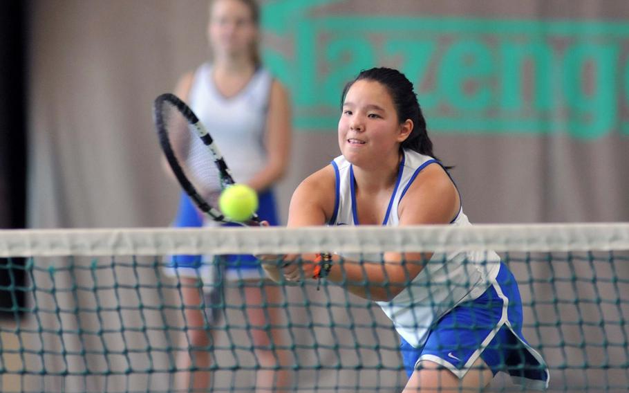 Ramstein's Jennifer Debose, returns a ball at the net, as teammate Hannah Hering watches. The pair took the girls doubles title at the 2013 DODDS-Europe tennis championships Oct. 26, 2013, defeating Wiesbaden's Peyton Taylor and Kate Connors 6-4, 3-6, 6-3.