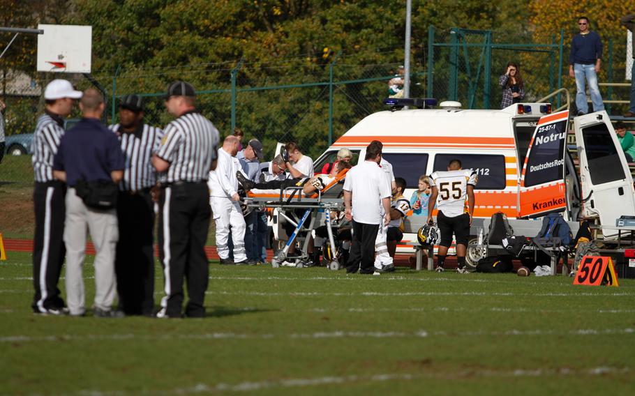 Officials confer as a handful of Patch players are attended to by medical personnel, moments before Patch coach Brian Hill threw in the towel with nearly nine minutes left to play. Hill told his team the game was out of reach, and he didn't want to see more of his players hurt. 