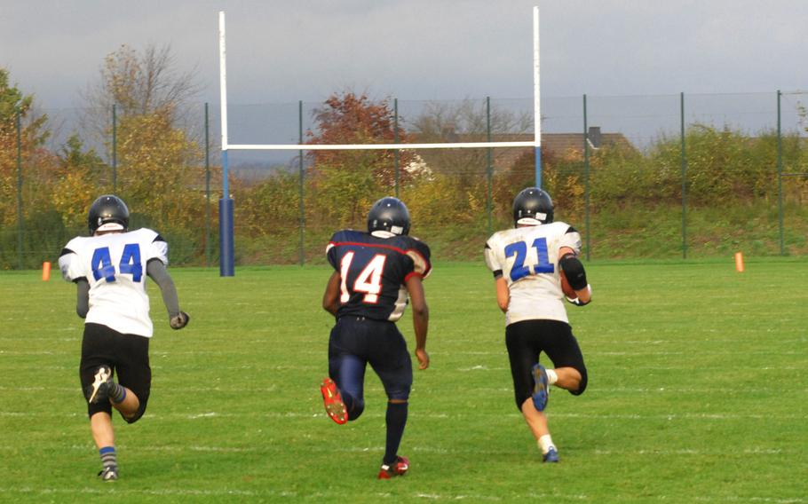 Hohenfels' David Vidovic outruns Bitburg's Larry Jackson for a touchdown after intercepting Bitburg's last-second pass attempt in Hohenfels' 38-28 Division II semifinal win Saturday, Oct. 26, at Bitburg, Germany.