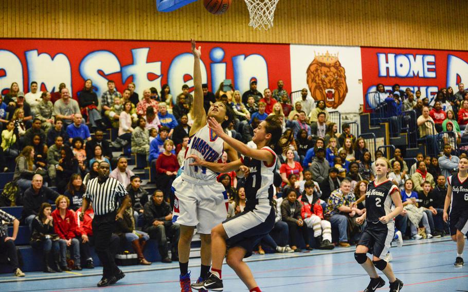 Ramstein's Desiree Palacios takes the ball to hoop against Bitburg's Hailey McKenna Friday night at Ramstein, Germany.