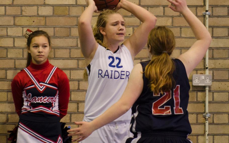 ISB's Kelsey Donnelly looks to put the ball in play while guarded by Lancer Kailey Kellner during a game at RAF Lakenheath, England, on Saturday.