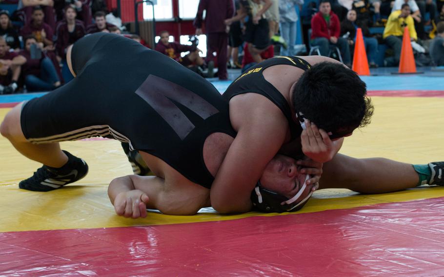 In a back-and-forth match, Kraig Sumpter of Vilseck struggles to escape the clutches of Patch wrestler Andrew Brabazon. Brabazon and Sumpter were the only two competitors in the 195-pound weight class and both moved on to the 220 pound weight class later in the day. Sumpter won the match. 
