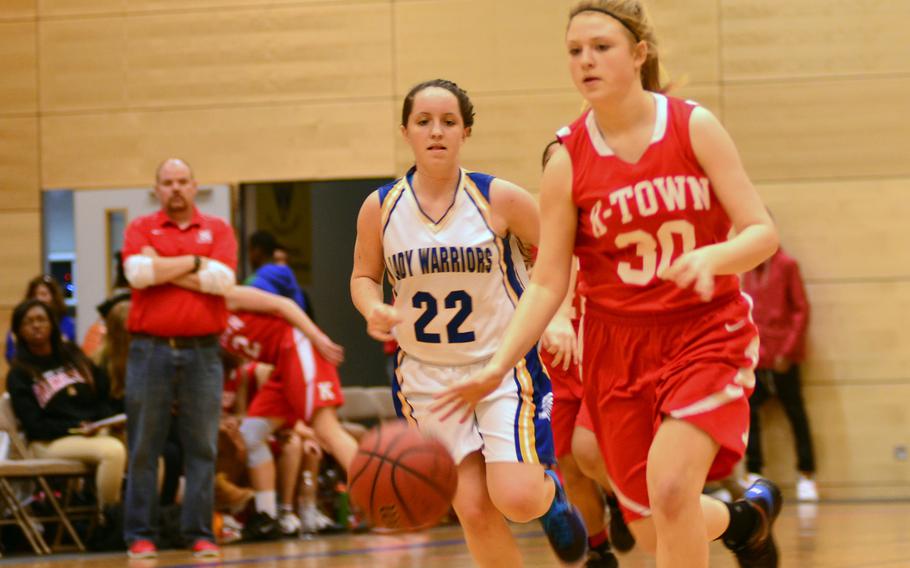 Kaiserslautern's Althea Honan dribbles past Wiesbaden's  Rebecca Russell on Saturday.  The Warriors went on to win in overtime 45-39.