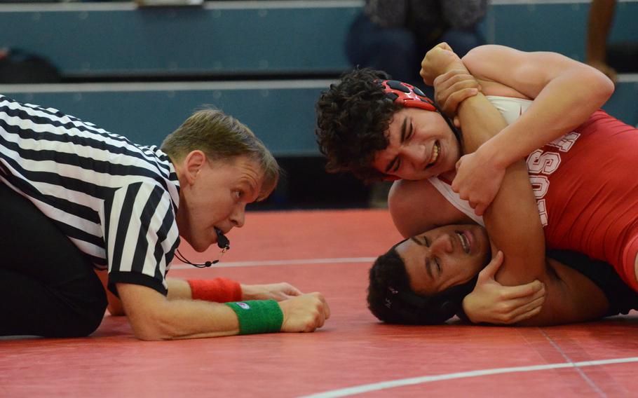 Referee Jon Ward watches as Emil Jurgens of American Overseas School of Rome attempts to pin Naples' Kory McKinney Saturday, during a 170-pound wrestling match at Aviano Air Base, Italy. McKinney would turn the match around and pin Jurgens in 5:20.