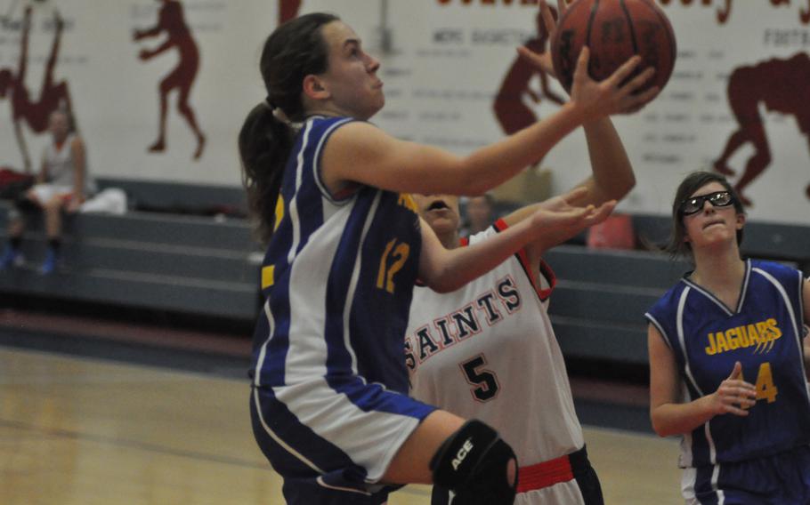 Sigonella's Kaite Cauble goes up for a basket Friday night in the Jaguars' 30-14 loss at Aviano.