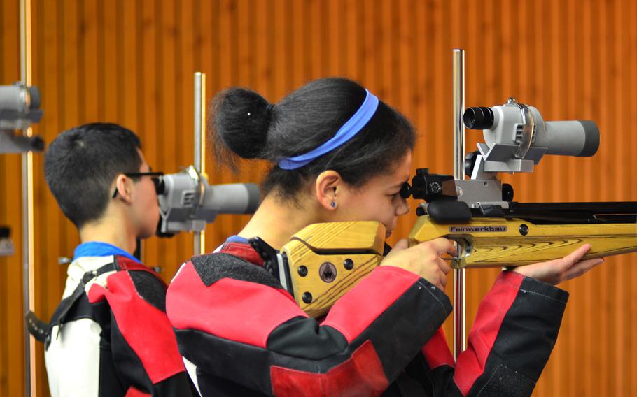 Baumholder shooter Selian Williams fine-tunes her rifle while her teammate Jesse Carillo checks his target using a monocular Saturday at a DODDS-Europe marksmanship competition in Wiesbaden, Germany.