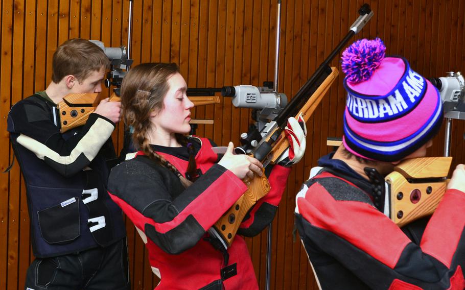 Patch's Benjamin Ferguson, left and Maggie Ehmann, center, compete from the standing position at a DODDS-Europe marksmanship competition Saturday in Wiesbaden, Germany.  The Warriors hosted teams from Alconbury, Baumholder, Patch, and Bitburg for the competition and will also host the DODDS-Europe 2013-14 European Championships on Feb 1
