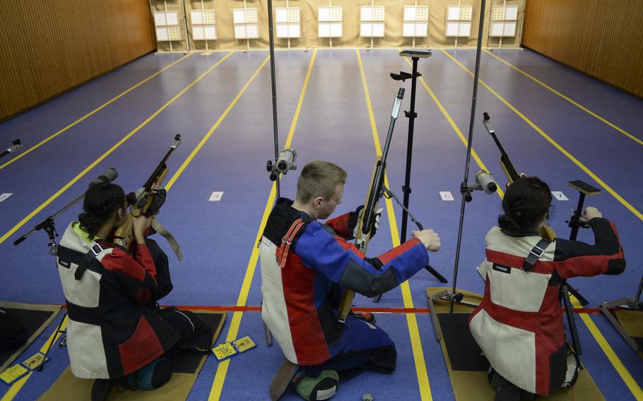 Vilseck's Chandler Johnson, left, Patch's Joshua Derner and Caeylin Miller shoot from the kneeling position in the DODDS-Europe Marksmanship Championship Saturday, Feb. 1, 2014 at Wiesbaden, Germany.