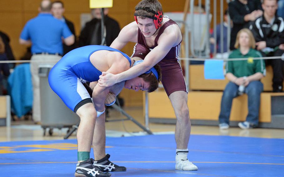 Aaron Norton of Brussels, left, and Michael Carter of Vilseck grapple in a 138-pound match in first round action on the first day of the DODDS-Europe wrestling championships in Wiesbaden, Germany, Friday, Feb. 14, 2014. Norton won the match.





