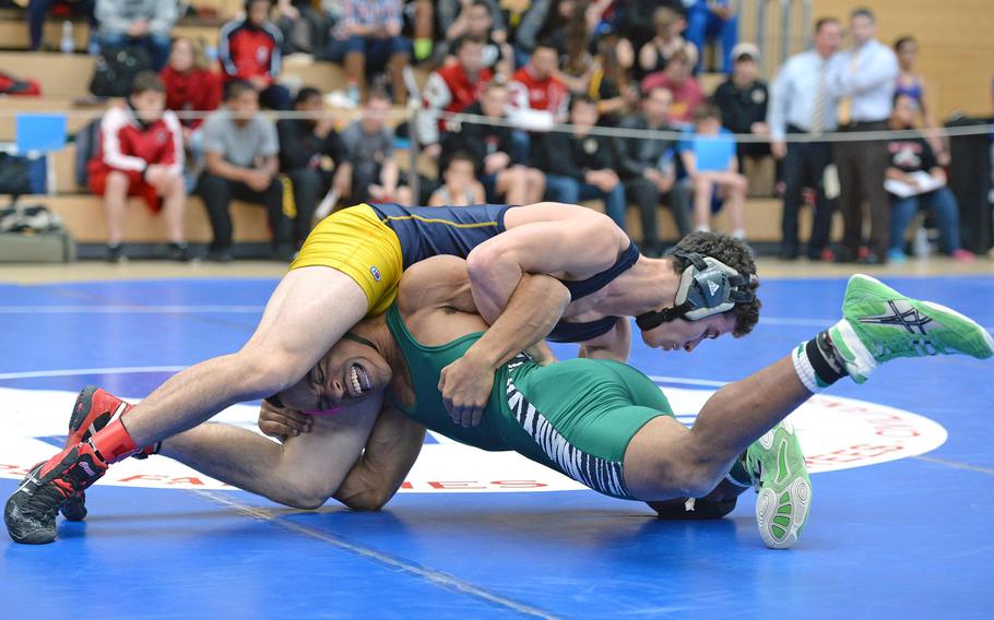 Ansbach's Shawn McDonald, top, beat Miles Davis of Naples in a 132-pound match in first round action on the first day of the DODDS-Europe wrestling championships in Wiesbaden, Germany, Friday, Feb. 14, 2014.





