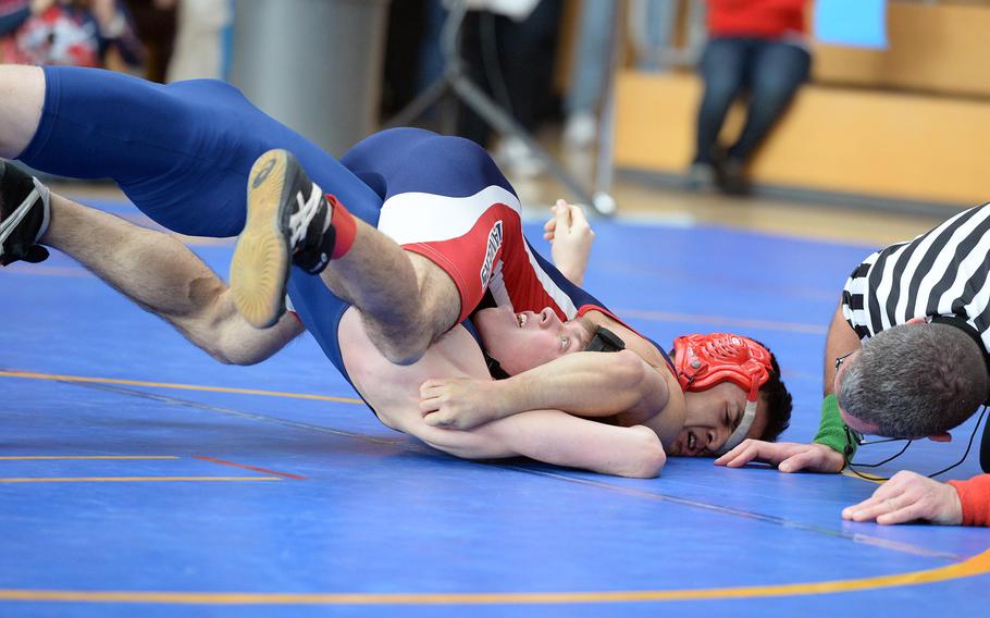 Black Forest Academy's David Crouch, left, struggles against Lakenheath's Keith Manibusan in a 126-pound match in first round action on the first day of the DODDS-Europe wrestling championships in Wiesbaden, Germany, Friday, Feb. 14, 2014.






