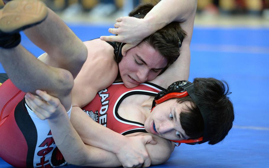 Vicenza's Drake Fichthorn, top beat Kaiserslautern's Evan Mackie in their 120-pound match in first round action on the first day of the DODDS-Europe wrestling championships in Wiesbaden, Germany, Friday, Feb. 14, 2014.





