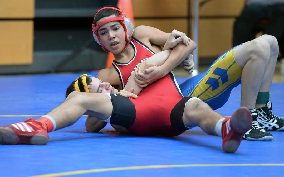 Kaiserslautern's Carlos Muniz, top, beat Ansbach's Jordan Lennon in a 113-pound match in first round action on the first day of the DODDS-Europe wrestling championships in Wiesbaden, Germany, Friday, Feb. 14, 2014.





