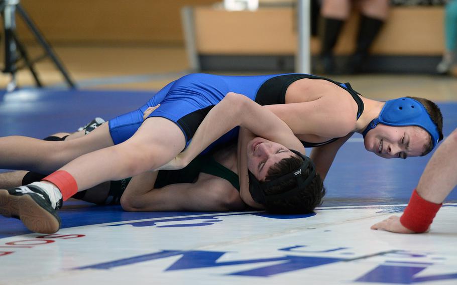 Incirlik's Baily Bennett, top, defeated Alec Williams of Naples in a 106-pound match in first round action on the first day of the DODDS-Europe wrestling championships in Wiesbaden, Germany, Friday, Feb. 14, 2014.





