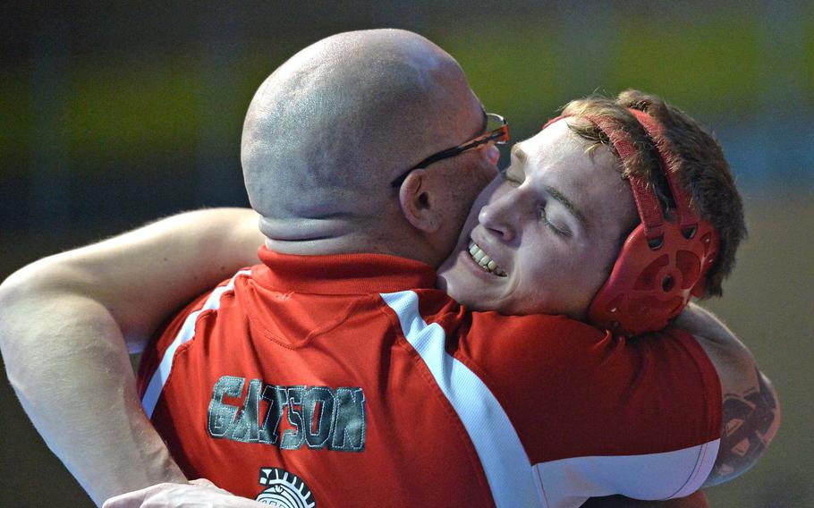 Kaiserslautern's Arvin Hrushka hugs coach Billy Gatson after beating Patch's Daniel Alvarado to win the 170-pound title match at the DODDS-Europe wrestling championships in Wiesbaden, Germany, Saturday, Feb. 15, 2014.


