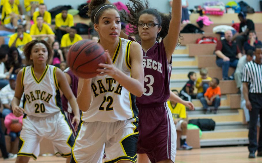 Lady Panther Meisha Blue grabs a pass while Vilseck's Vivian Tanner defends during the matchup between Patch and Vilseck, Feb. 15, 2014. Patch's Treshon Jenkins waits in the background. 