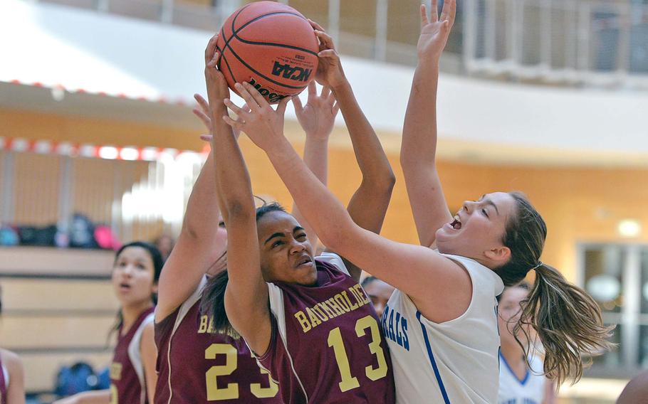 Baumholder's Faith Diaz, left, Kayla Robinson and Rota's Tasha Carlson fight for a rebound in Rota's 34-28 win in opening day girls Division II action at the DODDS-Europe basketball championships in Wiesbaden, Germany, Wednesday, Feb. 19, 2014.