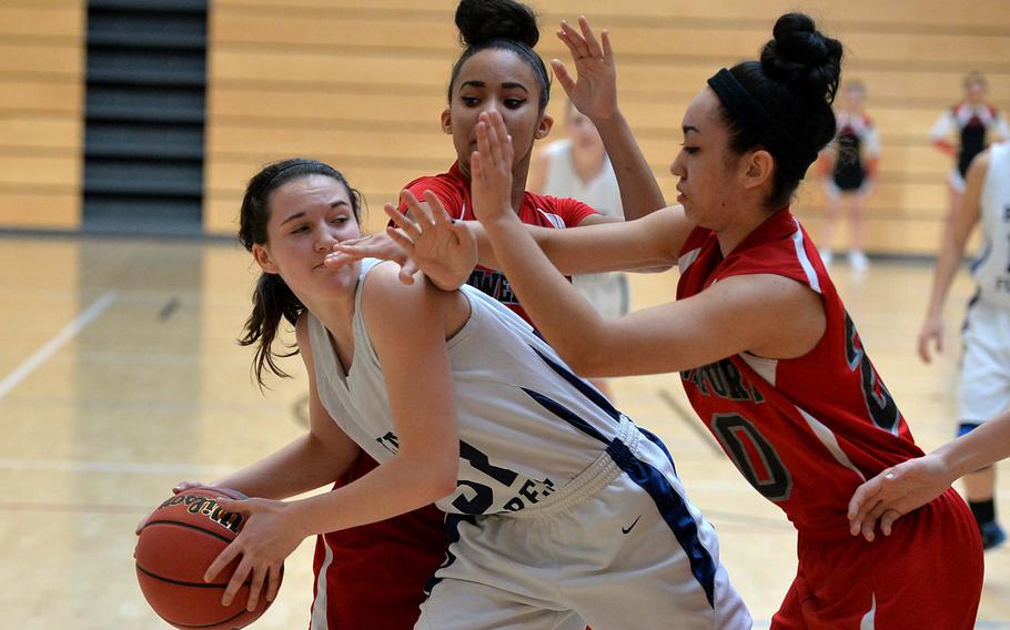 Bamberg/Schweinfurt's Jessilyn Smith, center, and Ariana Diaz try to keep Black Forest Academy's Hannah Harrop from passing in BFA's 46-12 win in Division II action at the DODDS-Europe basketball championships in Wiesbaden, Germany, Wednesday, Feb. 19, 2014.