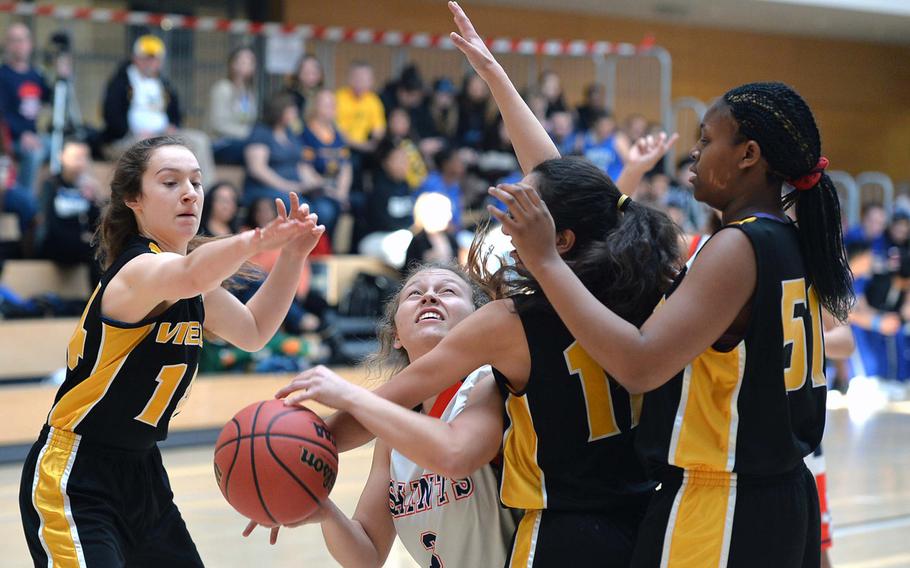 Aviano's Sadie Hellwig looks for a shot against the Vicenza defense of Emma Knapp, left, Victoria Porras and Kianna Grant  girls Division II action at the DODDS-Europe basketball championships in Wiesbaden, Germany, Wednesday, Feb. 19, 2014. Aviano beat Vicenza 23-21.