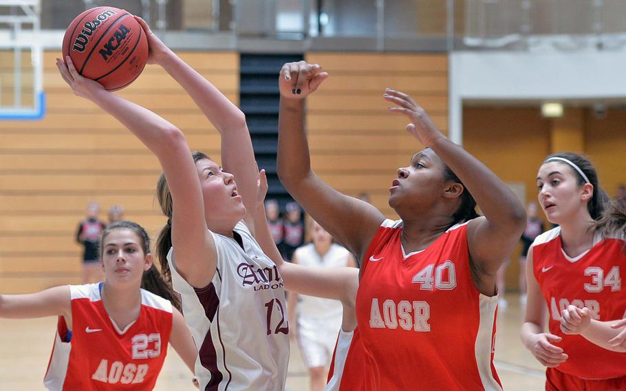 AFNORTH's Eliska Volencova shoots over American Overseas School of Rome's Margo Snipe in girls Division II action at the DODDS-Europe basketball championships in Wiesbaden, Germany, Wednesday, Feb. 19, 2014. AFNORTH defeated AOSR 32-6.