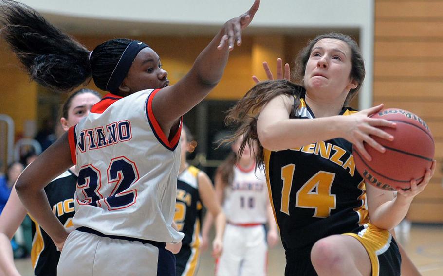 Vicenza's Emma Knapp scores against Aviano's Jasmine Cole girls Division II action at the DODDS-Europe basketball championships in Wiesbaden, Germany, Wednesday, Feb. 19, 2014. Aviano won the game 23-21.


