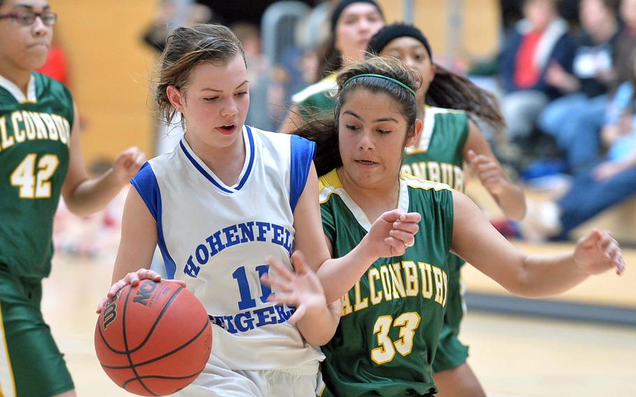 Shelby Atkinson of Hohenfels drives against Alconbury's Roni Teti in girls Division II action at the DODDS-Europe basketball championships in Wiesbaden, Germany, Wednesday, Feb. 19, 2014. Hohenfels beat Alconbury 31-19.