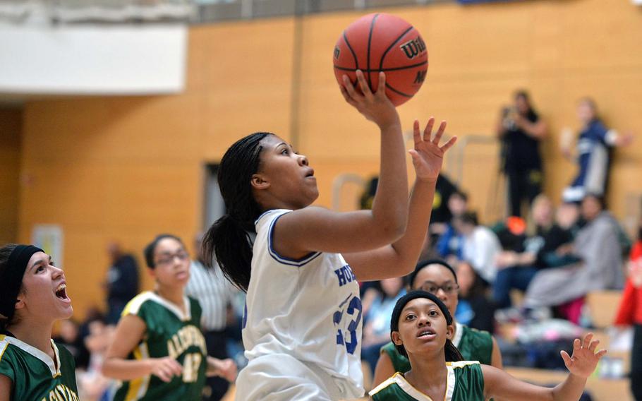 Tamia McDaniels takes a running jumper in the Tigers' 31-19 win over Alconbury in opening day Division II action at the DODDS-Europe basketball championships in Wiesbaden, Germany, Wednesday, Feb. 19, 2014. At left is Alconbury's Leila Hall, at right Jiya Green.