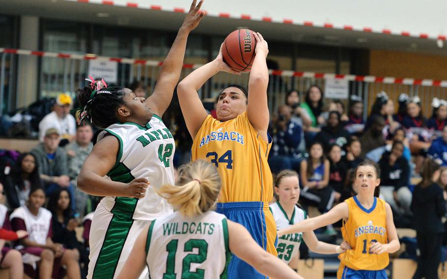 Ansbach's Alyssa Solis shoots over Shanice Alexander of Naples as their teammates watch the action in a Division II game at the DODDS-Europe basketball championships in Wiesbaden, Germany, Wednesday, Feb. 19, 2014. Naples beat Ansbach 36-21.