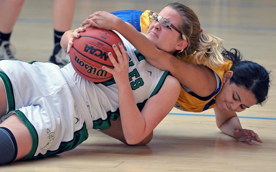 Carrie Welch of Naples and Ansbach's Reiwan Hussein fight for the ball in girls Division II action at the DODDS-Europe basketball championships in Wiesbaden, Germany, Wednesday, Feb. 19, 2014. Naples beat Ansbach 36-21.





