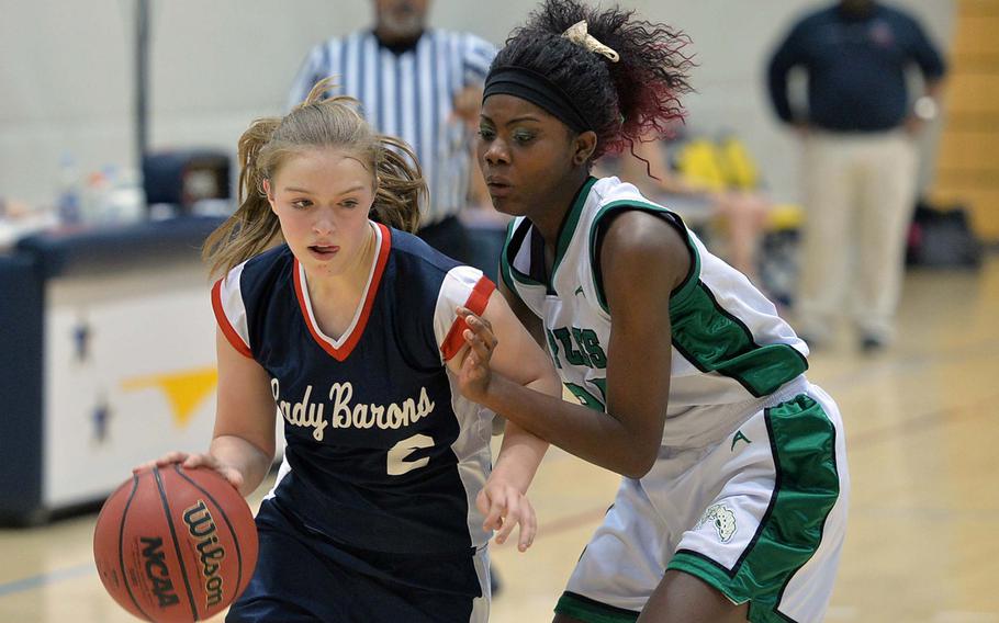 Bitburg's Alexa Landenberger, left, drives towards the basket against Naples' Ashley Forte in Division II action at the DODDS-Europe basketball championships in Wiesbaden, Germany, Wednesday, Feb. 19, 2014. Naples won 18-16.
