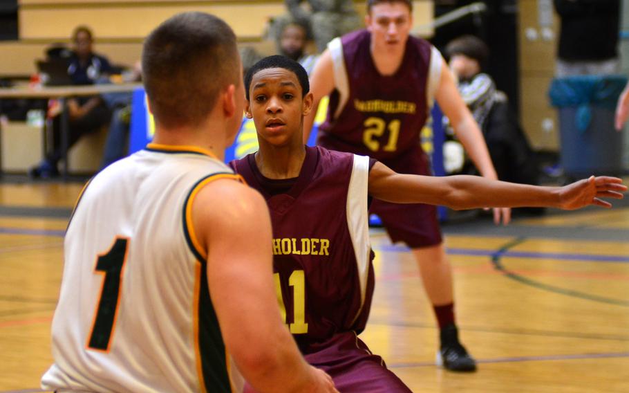 Baumholder Bucs freshman guard Hyshone Fisher covers SHAPE's Conner Manning during the 2014 DODDS-Europe Championships in Wiesbaden.  SHAPE beat Baumholder 68-28 in the first day of Division II play.