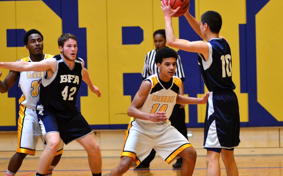 Black Forest Academy senior Peter Ling prepares to pass the ball to fellow senior Roger Higby during the 2014 DODDS-Europe basketball championships in Wiesbaden, Germany, Wednesday, Feb. 19, 2014. Higby scored a team high of nine points against the Cougars.